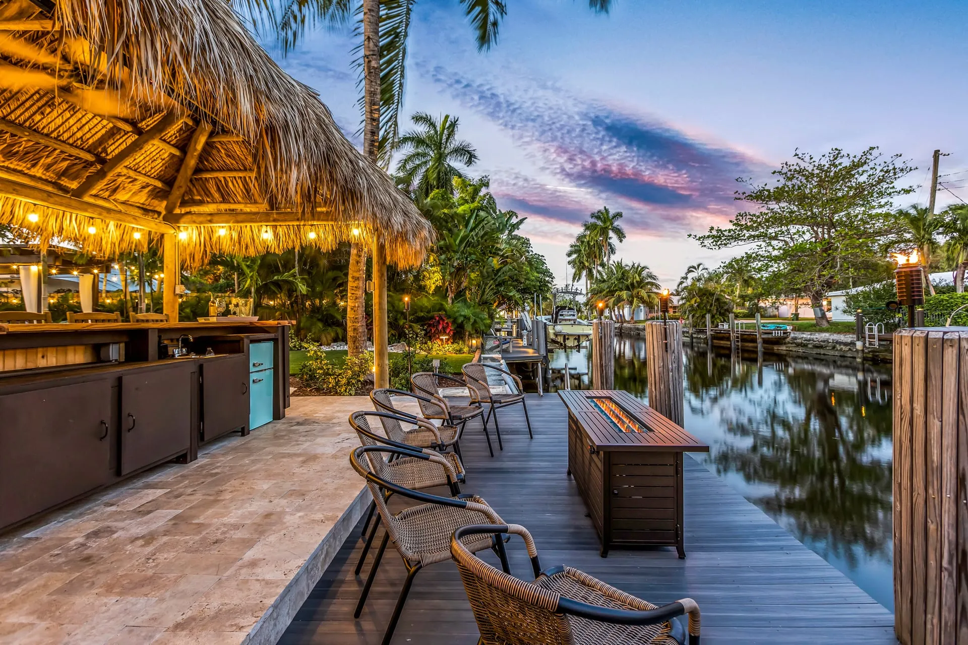 Tiki bar and dock on the canal at 2004 NE 17th Way, at twilight